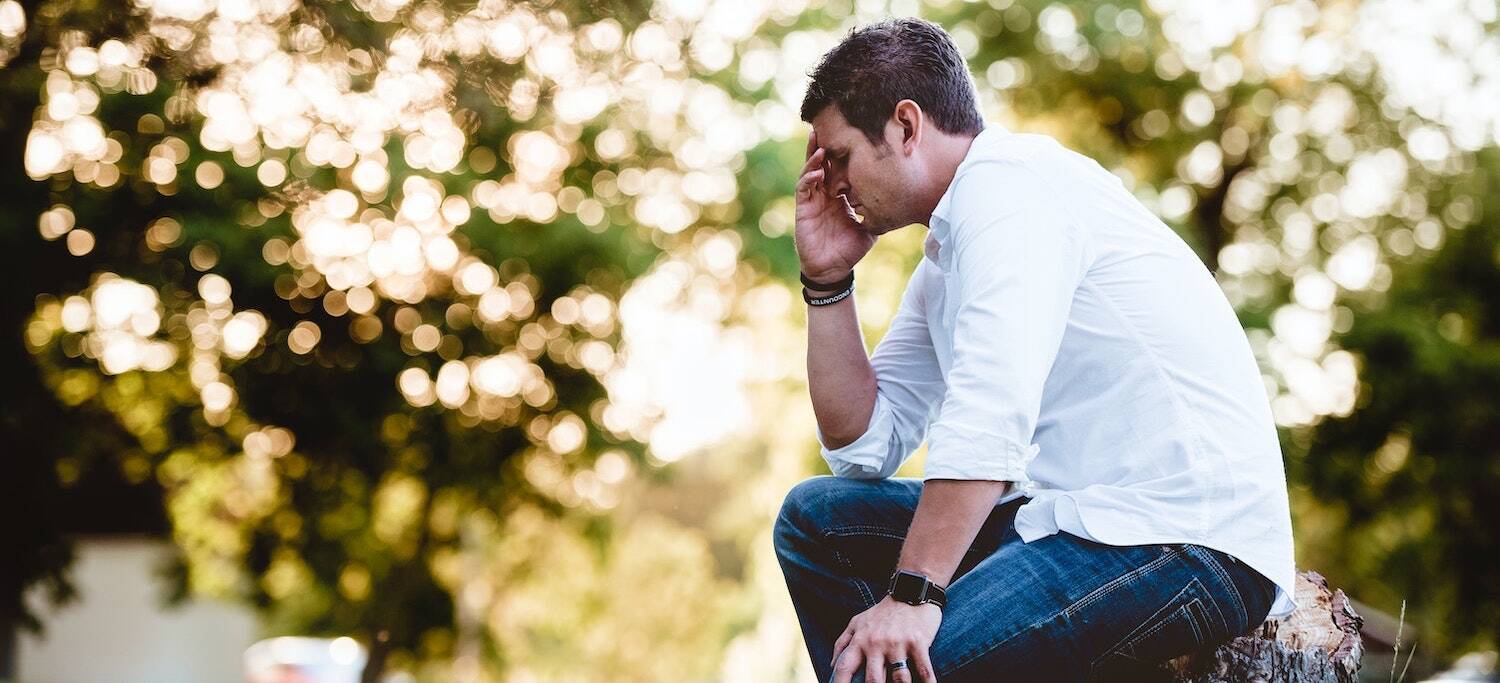 Man hold his face in his hands in guilt